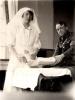 Photo #64
Nurse Redressing 
Soldiers wounded leg
